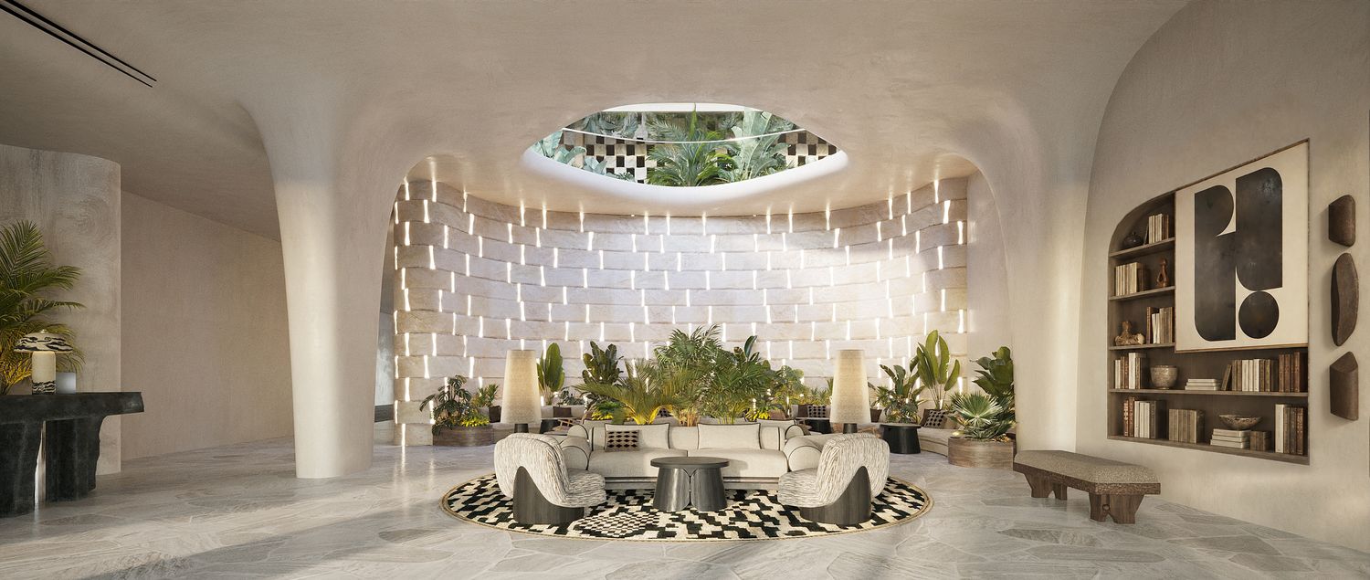 Ampersand Beach House, Dubai Islands — the lobby, lit stone wall and planted atrium
